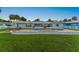 Well-manicured backyard with a pool, brick patio, and a cozy fire pit area at 5809 Riverside Dr, Port Orange, FL 32127