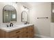Bathroom featuring a double vanity with modern fixtures and a glass-enclosed shower at 5809 Riverside Dr, Port Orange, FL 32127