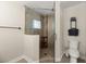 Bathroom with a glass shower door, neutral tile shower, and a modern toilet at 5809 Riverside Dr, Port Orange, FL 32127