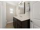 Bathroom featuring a modern vanity with marble countertop, dark cabinetry, and neutral wall paint at 5809 Riverside Dr, Port Orange, FL 32127