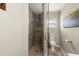 Modern bathroom featuring a glass shower door, neutral tile shower and toilet at 5809 Riverside Dr, Port Orange, FL 32127
