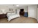 Spacious bedroom featuring light wood floors, a ceiling fan, and beach-themed decor at 5809 Riverside Dr, Port Orange, FL 32127