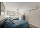 Bedroom featuring two twin beds with blue quilted comforters, wood flooring, and ample natural light at 5809 Riverside Dr, Port Orange, FL 32127