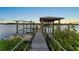 Scenic boat dock featuring a boat lift and canopy for convenient water access and boat storage at 5809 Riverside Dr, Port Orange, FL 32127