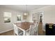 Dining room featuring a wood table, six chairs, and access to the living room and outdoor patio at 5809 Riverside Dr, Port Orange, FL 32127