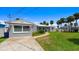 Attractive single-story home with lush green lawn and a long driveway, offering great curb appeal at 5809 Riverside Dr, Port Orange, FL 32127