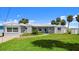 Inviting single-story home with a well-manicured lawn and lush landscaping at 5809 Riverside Dr, Port Orange, FL 32127