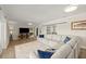 Spacious living room with a large sectional, and sliding doors for seamless indoor-outdoor living at 5809 Riverside Dr, Port Orange, FL 32127