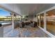 This covered outdoor patio features tile floors and views of the waterfront at 5809 Riverside Dr, Port Orange, FL 32127