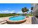 This kidney-shaped pool is surrounded by pavers and has views of the bay at 5809 Riverside Dr, Port Orange, FL 32127