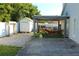 Relaxing backyard featuring a covered patio, shed, and well-maintained pavers at 8958 Fort Jefferson Blvd, Orlando, FL 32822