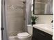 This bathroom has a tiled shower, updated sink and faucet, and sleek modern design at 8958 Fort Jefferson Blvd, Orlando, FL 32822