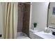 This bathroom features a shower and tub combination with a modern vanity and mirror at 8958 Fort Jefferson Blvd, Orlando, FL 32822
