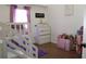 Bright and spacious bedroom with a bunk bed, white dresser, and wood flooring at 8958 Fort Jefferson Blvd, Orlando, FL 32822