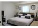 Comfortable bedroom features neutral colors, two side tables and clean white curtains at 8958 Fort Jefferson Blvd, Orlando, FL 32822