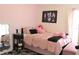 Cozy bedroom featuring a full-sized bed with a pink comforter and stylish decor at 8958 Fort Jefferson Blvd, Orlando, FL 32822