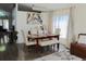 Elegant dining area with seating for six, decorative chandelier and artwork, and natural light at 8958 Fort Jefferson Blvd, Orlando, FL 32822