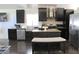 Modern kitchen with dark cabinetry, stainless steel appliances, island, and great countertop space at 8958 Fort Jefferson Blvd, Orlando, FL 32822