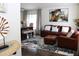 Inviting living room featuring a comfortable leather sofa and stylish decor, adjacent to a dining area at 8958 Fort Jefferson Blvd, Orlando, FL 32822