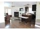 Open floor plan featuring the fireplace, kitchen, and breakfast bar, perfect for modern living at 8958 Fort Jefferson Blvd, Orlando, FL 32822