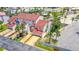 Aerial view of a multi-story townhouse featuring a red roof, a driveway, a garage, and palm trees at 200 Florida Shores Blvd, Daytona Beach, FL 32118