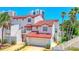 Beautiful multi-level home featuring red-tiled roof, a two-car garage and mature palm trees in the front yard at 200 Florida Shores Blvd, Daytona Beach, FL 32118