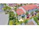 Striking white two-story townhome showcasing a red roof, enclosed patio, and lush landscaping at 200 Florida Shores Blvd, Daytona Beach, FL 32118