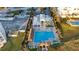 Aerial view of the community pool with seating areas, palm trees, and poolside amenities at 324 Coral Reef Way, Daytona Beach, FL 32124