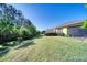 Well-maintained backyard with green lawn and view of the neighborhood at 324 Coral Reef Way, Daytona Beach, FL 32124
