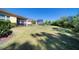 Lush backyard with a screened lanai, pool area, and scenic views at 324 Coral Reef Way, Daytona Beach, FL 32124