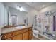 Bathroom with a decorative shower curtain, large mirror, and wooden vanity at 324 Coral Reef Way, Daytona Beach, FL 32124