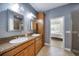 Bathroom featuring a double sink vanity, a large mirror, and a shower at 324 Coral Reef Way, Daytona Beach, FL 32124
