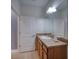 Bathroom featuring a wooden vanity, a large mirror, and a tiled floor at 324 Coral Reef Way, Daytona Beach, FL 32124