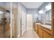 Bathroom featuring a double sink vanity, a large mirror, and a glass shower at 324 Coral Reef Way, Daytona Beach, FL 32124