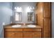 Bathroom featuring a double sink vanity, a large mirror, and a full-height storage cabinet at 324 Coral Reef Way, Daytona Beach, FL 32124