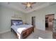 Bedroom with a ceiling fan, tray ceiling, and an attached room at 324 Coral Reef Way, Daytona Beach, FL 32124