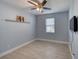 Bright bedroom with wood floors, ceiling fan, and natural light from the window at 324 Coral Reef Way, Daytona Beach, FL 32124