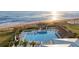 Aerial view of a community pool, showcasing its sparkling water, surrounding cabanas, and lush landscaping at 324 Coral Reef Way, Daytona Beach, FL 32124
