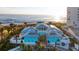 Beautiful oceanfront property with turquoise accents, a metal roof, and lush landscaping at 324 Coral Reef Way, Daytona Beach, FL 32124