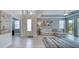Bright living room with tile flooring, large windows, modern decor, and an open floor plan at 324 Coral Reef Way, Daytona Beach, FL 32124