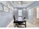 A cozy office space with neutral walls, white trim, and a view to the entry foyer at 324 Coral Reef Way, Daytona Beach, FL 32124