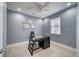 Cozy office space with a ceiling fan, neutral walls, and bright light from the large window at 324 Coral Reef Way, Daytona Beach, FL 32124