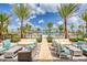 Outdoor lounge area with comfortable seating, palm trees, and pool views at 324 Coral Reef Way, Daytona Beach, FL 32124