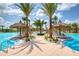 Beach cabanas and lounge chairs surround this lagoon style pool, a beautiful place to relax at 324 Coral Reef Way, Daytona Beach, FL 32124