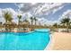 A resort style pool with bridge and beach cabanas with lounging chairs at 324 Coral Reef Way, Daytona Beach, FL 32124