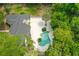 Aerial view showcasing a private backyard oasis with a sparkling pool and lush landscaping at 530 Estates Pl, Longwood, FL 32779