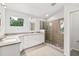 Bathroom showcasing a glass enclosed shower, white cabinets, and a large granite countertop at 530 Estates Pl, Longwood, FL 32779