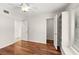 Bedroom with hardwood floors, a ceiling fan, and built-in storage at 530 Estates Pl, Longwood, FL 32779