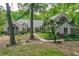 Stunning home featuring a lush green lawn, mature trees, and unique architectural details at 530 Estates Pl, Longwood, FL 32779