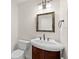 Small half bathroom with pedestal sink and mosaic-framed mirror at 530 Estates Pl, Longwood, FL 32779